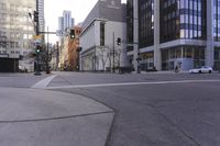 the empty city street with buildings and cars on it's side and streets at an intersection in the middle