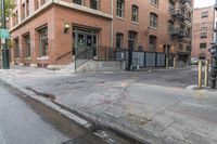 the corner of a city street where an empty street has been cleaned with asphalt and other signs