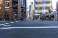 a view down a deserted street with high rise buildings behind it in downtown minneapolis,
