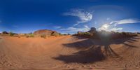 a fish eye view of desert area from a video game camera screen shows the ground and palm trees