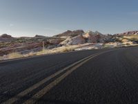 a motorcycle parked on the side of a road in the desert at sunset time in southwest nevada