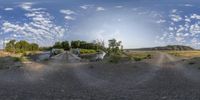 the small bridge over the dirt road is clearly visible, the image is 360 - fish eye