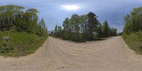 this is a picture of a dirt path with two camera flashes in the sky over it