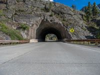 a road goes into a tunnel and through the hill to the other side of it