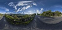 an image of a curved road on a sunny day in the mountains on a cloudy day