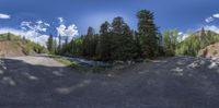 a scenic road is captured with an amazing sky view through the fisheye lens pan