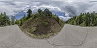 two identical 360 - cameras, one shows the road in between them and the other shows a green hill on either side