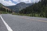 the road leading to the mountain is empty for cars to drive down from it,