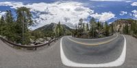 a winding road is seen through two fisheyes in a fisheye lens image