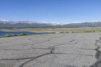 there is an empty parking lot at the bottom of the mountain range in colorado it's very empty, but still very empty