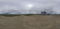 a panoramic image of the power lines from the road below it on a cloudy day