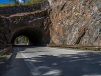 a road goes into a tunnel and through the hill to the other side of it