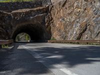 a road goes into a tunnel and through the hill to the other side of it