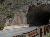 a road goes into a tunnel and through the hill to the other side of it