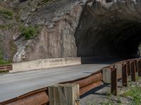 a road goes into a tunnel and through the hill to the other side of it