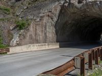 a road goes into a tunnel and through the hill to the other side of it