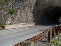 a road goes into a tunnel and through the hill to the other side of it