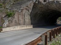 a road goes into a tunnel and through the hill to the other side of it