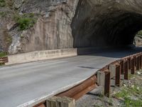 a road goes into a tunnel and through the hill to the other side of it