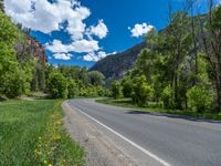 the red rocks are high up on the side of the road and it is an amazing color