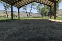 a tent with hay is sitting in the yard at the ranch in wyoming, usa