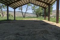 a tent with hay is sitting in the yard at the ranch in wyoming, usa