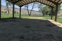 a tent with hay is sitting in the yard at the ranch in wyoming, usa