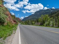 the red rocks are high up on the side of the road and it is an amazing color