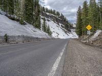 Colorado Landscape: A Snowy Road Under Cloudy Skies