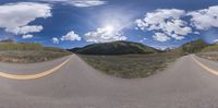 two wide shot lens panoramas of an empty mountain highway next to mountains and trees