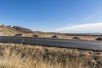 this is a shot of the road on the hillside with no cars in it and one lane that looks similar to the highway