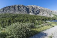 the trail is along the lake and in the mountains at an angle that could be a great spot for backpacking