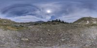 a photo taken from a virtualized picture shows the mountain landscape and sky with a full moon in the distance