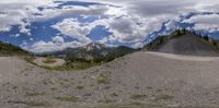 panorama fisheye image of mountain range on a cloudy day with no clouds in sight