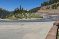 the road looks out into the mountains, with a winding bend along it at least half of which