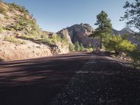 a paved mountain road with no traffic as an emergency vehicle crosses the corner of it