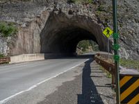 a road goes into a tunnel and through the hill to the other side of it