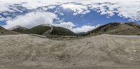 the view of a curved mountain highway in 360 - angle perspective, with one person driving down it