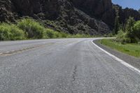 the road is empty for traffic as the motorcycle rides along it's course in the mountains