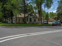 a road and trees line a residential street in a residential area in a neighborhood with no parking