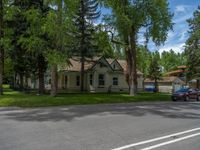 a road and trees line a residential street in a residential area in a neighborhood with no parking