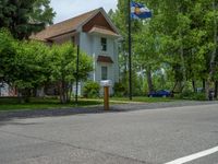 an empty street lined with trees and a mountain range in the distance in the back