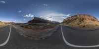 an empty highway runs along the edge of the desert in an 360 - ray fisheye