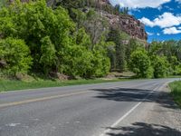 the red rocks are high up on the side of the road and it is an amazing color