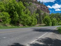 the red rocks are high up on the side of the road and it is an amazing color