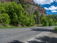 the red rocks are high up on the side of the road and it is an amazing color