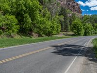 the red rocks are high up on the side of the road and it is an amazing color