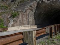 a road goes into a tunnel and through the hill to the other side of it