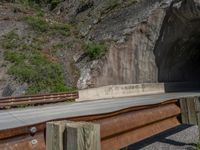 a road goes into a tunnel and through the hill to the other side of it