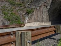 a road goes into a tunnel and through the hill to the other side of it